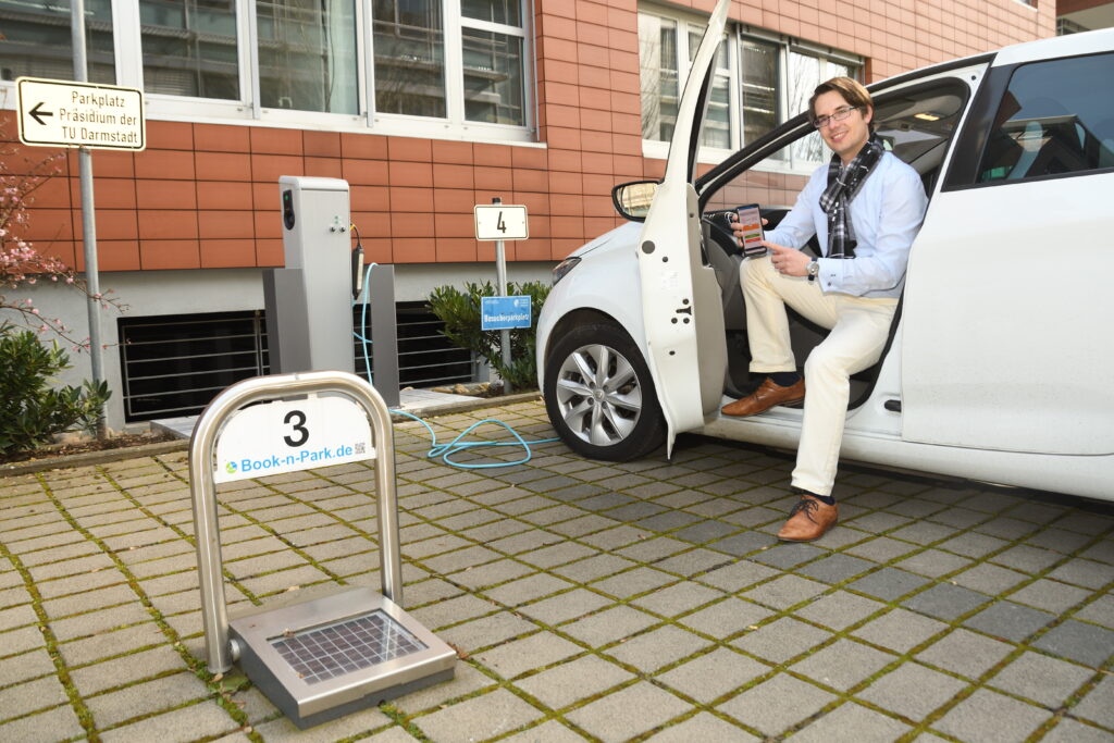 Electric charging area with parking bar